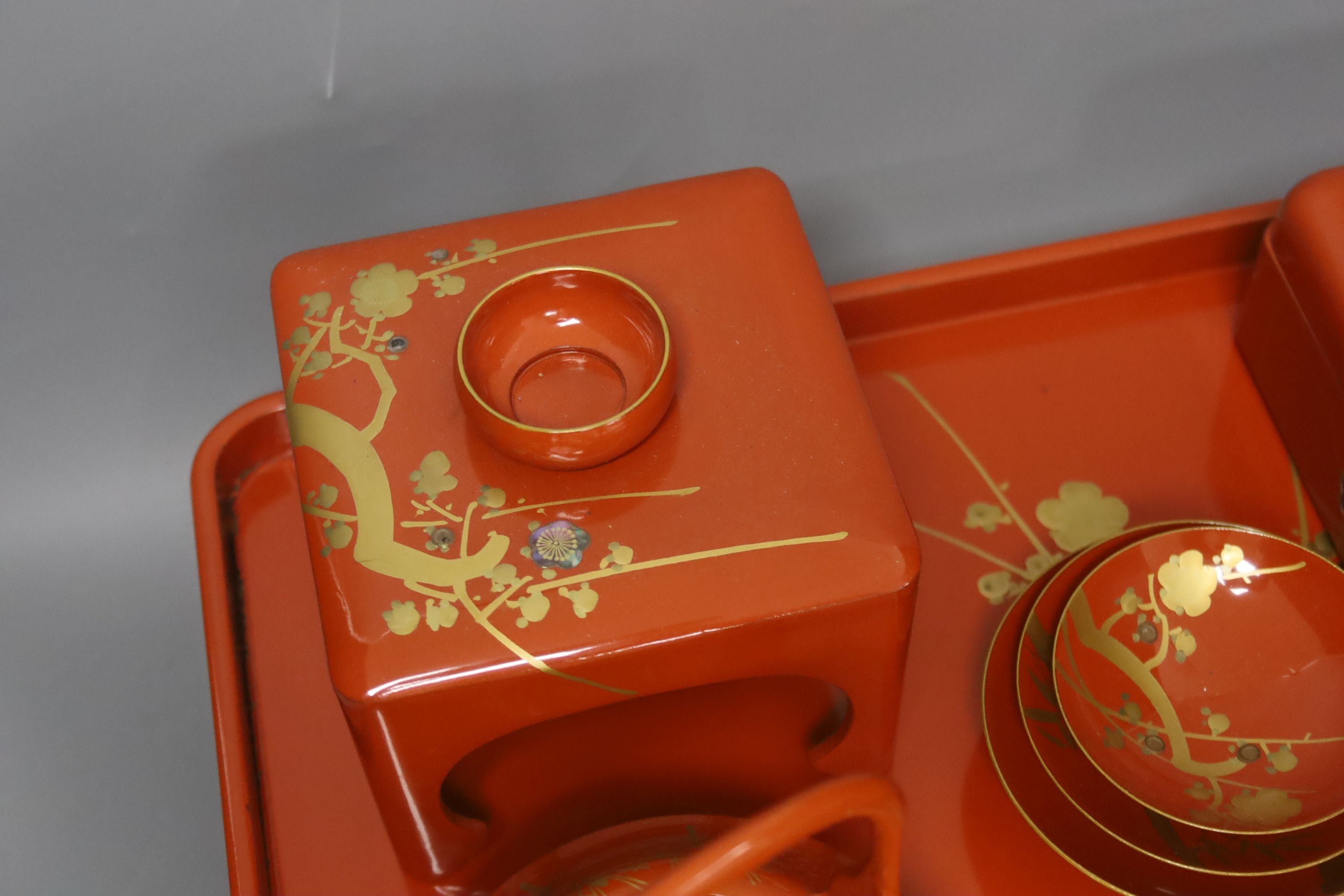 A Japanese red lacquer ceremonial sake set
